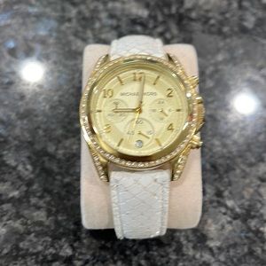 Used Michael Kors watch. Shows signs on wear. Needs a new battery